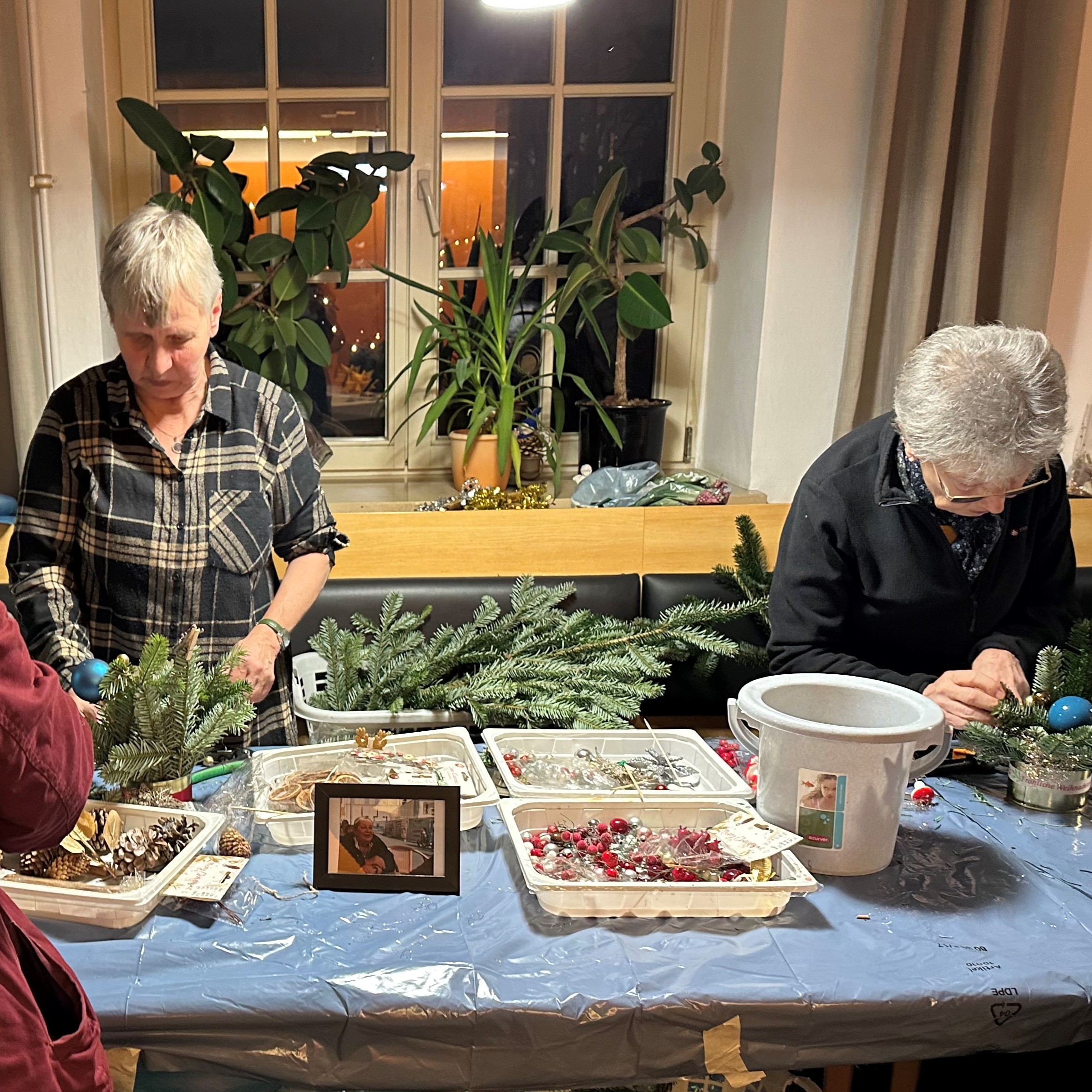 Gestecke basteln beim Voithea-Adventsmarkt © Paul-Riebeck-Stiftung Voithea-Adventsmarkt in der Paul-Riebeck-Stiftung: Zwei Seniorinnen basteln Gestecke für Weihnachten